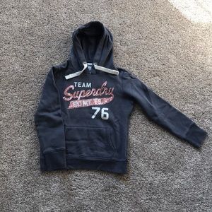 Superdry sweater in blue with pink writing on it